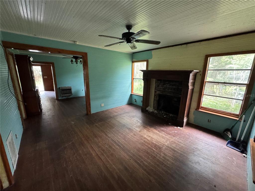850 Menton Road Pierson, FL 32180 - Photo 12 of 35 an empty room with windows and a fireplace