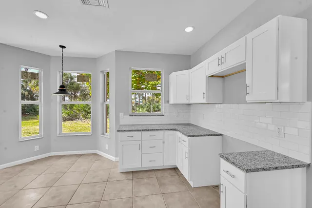 a kitchen with a stove a sink and a window