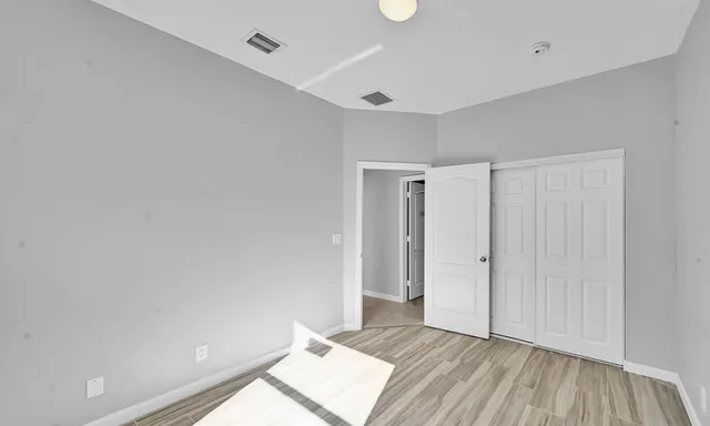a view of an empty room and wooden floor
