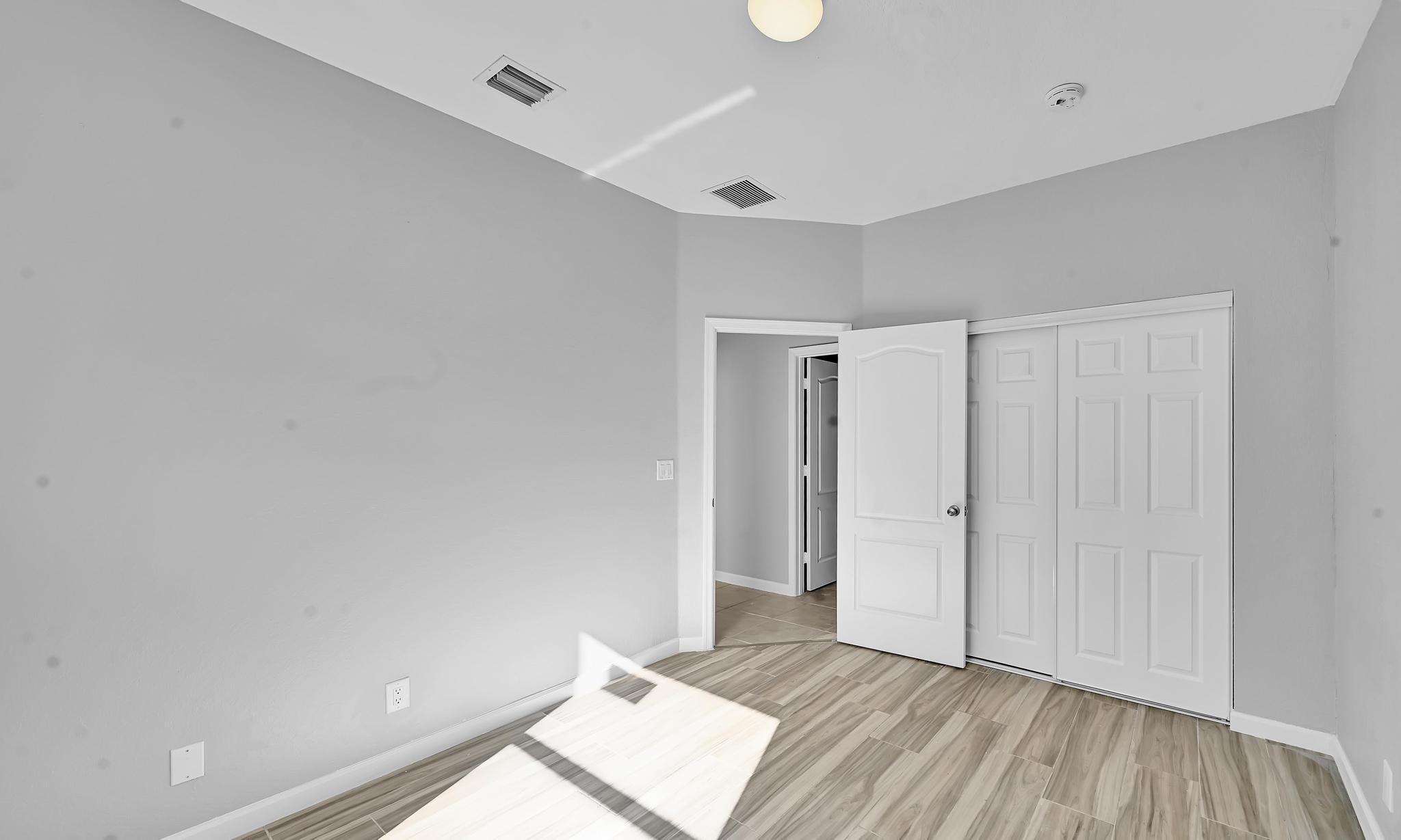 5557 Spanish River Road Fort Pierce, FL 34951 - Photo 20 of 28 a view of an empty room and wooden floor