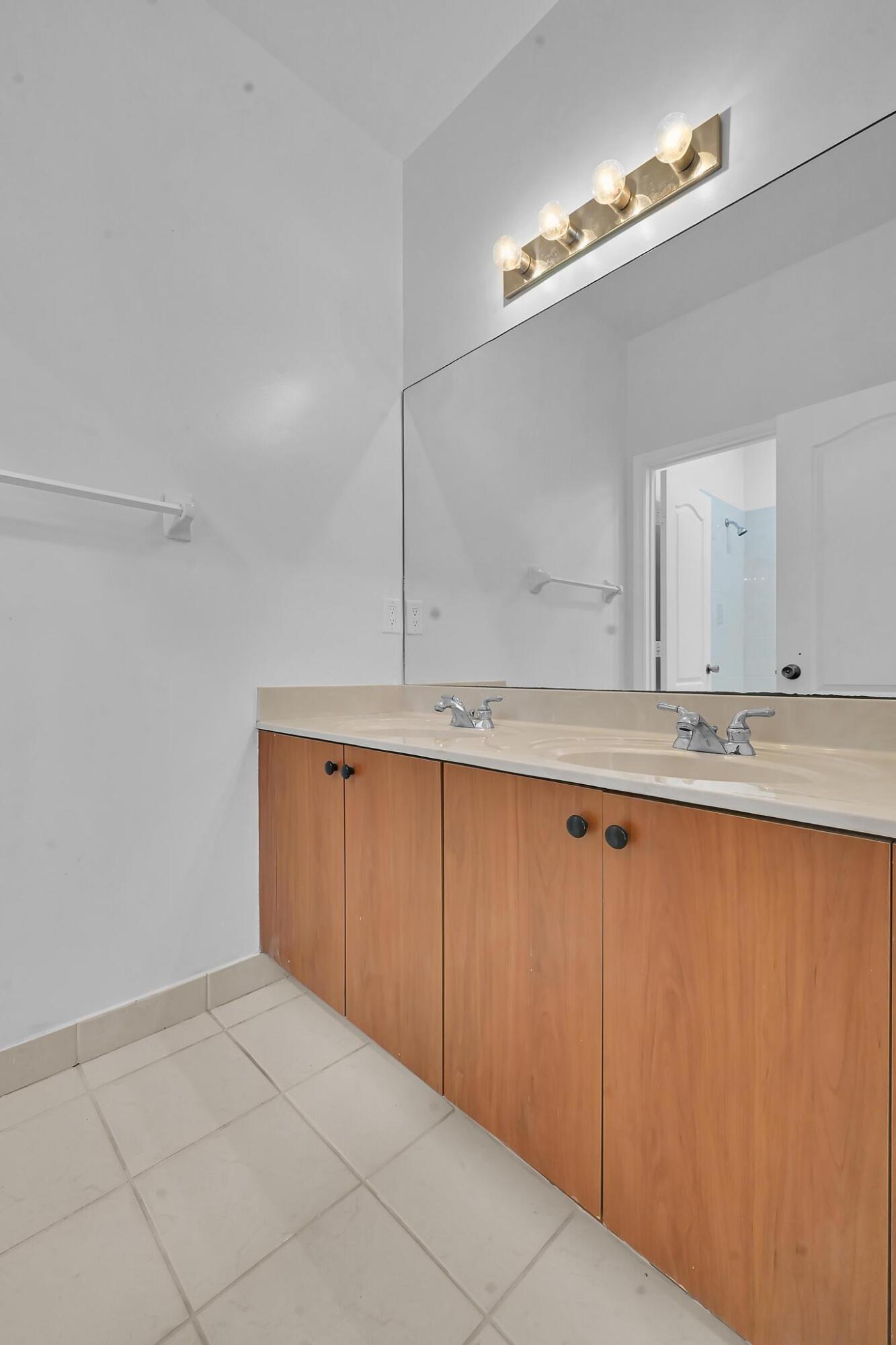 5557 Spanish River Road Fort Pierce, FL 34951 - Photo 22 of 28 a view of a kitchen with wooden cabinets