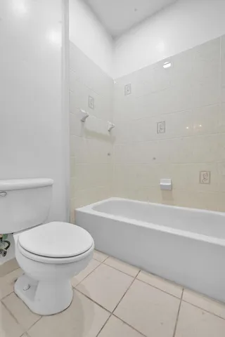 a bathroom with a toilet and a bathtub