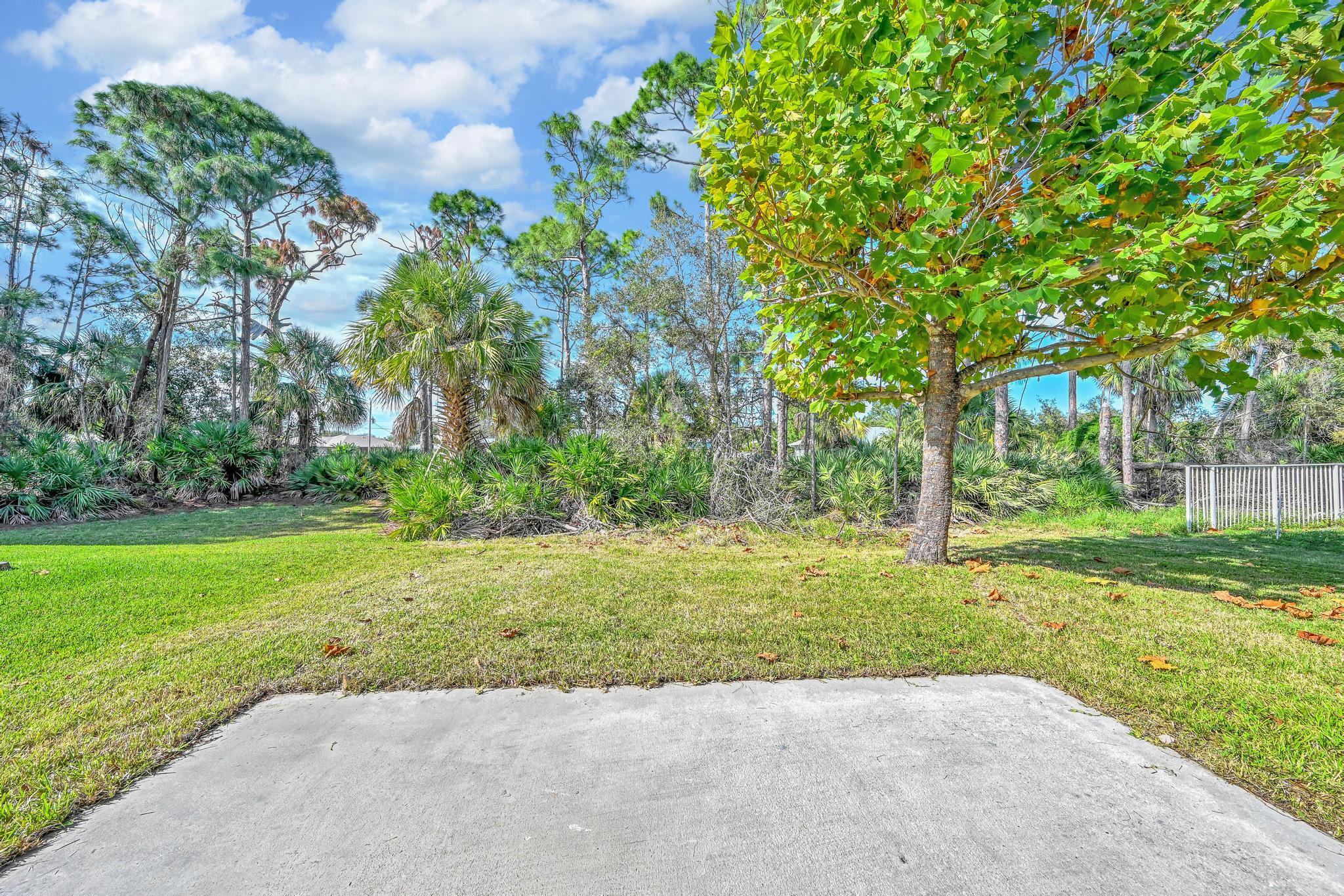 5557 Spanish River Road Fort Pierce, FL 34951 - Photo 28 of 28 a view of a yard with plants and trees