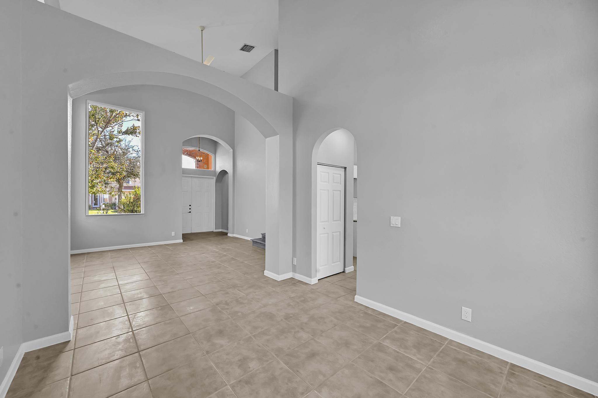 5557 Spanish River Road Fort Pierce, FL 34951 - Photo 5 of 28 an empty room with windows and closet