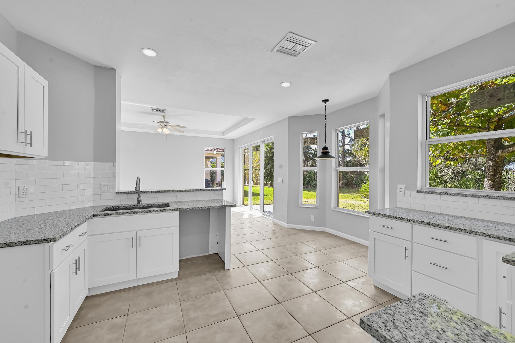 5557 Spanish River Road Fort Pierce, FL 34951 - Photo 9 of 28 a kitchen with a sink and cabinets