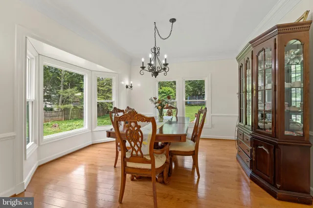 a view of a dining room with furniture and a chandelier