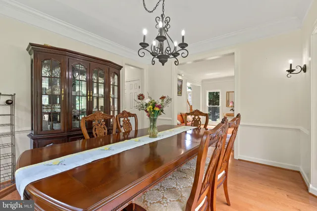 a view of a dining room with furniture and chandelier