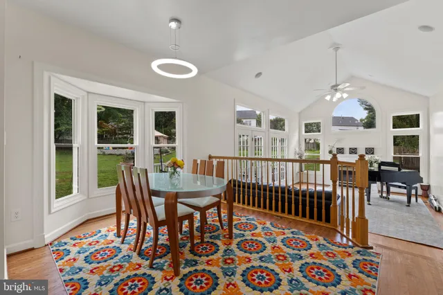 a dining room with furniture a chandelier and wooden floor