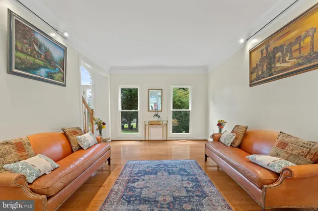 a living room with furniture flat screen tv and a large window