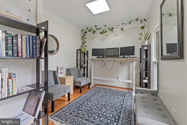 a bedroom with a bed and a mirror on dresser