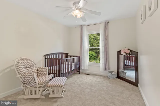 a bedroom with a bed next to a window and a flat screen tv
