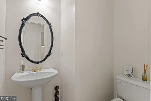 a living room with furniture a piano and a bookshelf