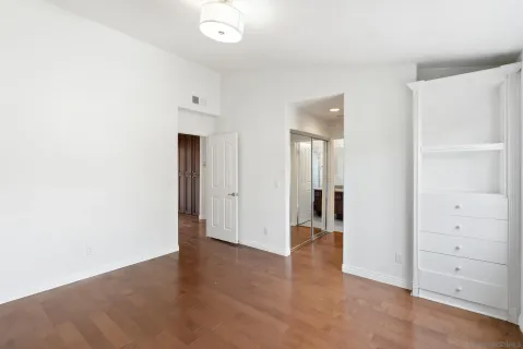 a view of an empty room with wooden floor
