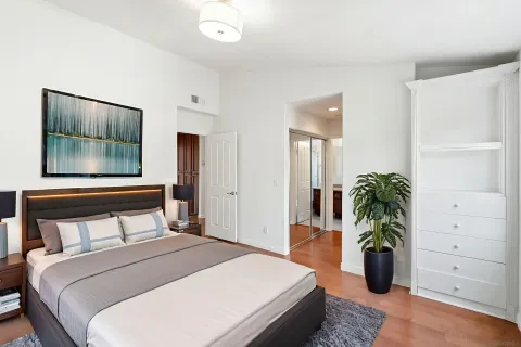 a bedroom with a bed and a potted plant