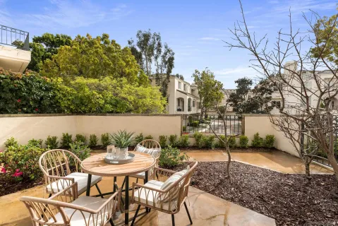 a backyard of a house with table and chairs