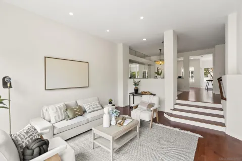 a living room with furniture and a painting