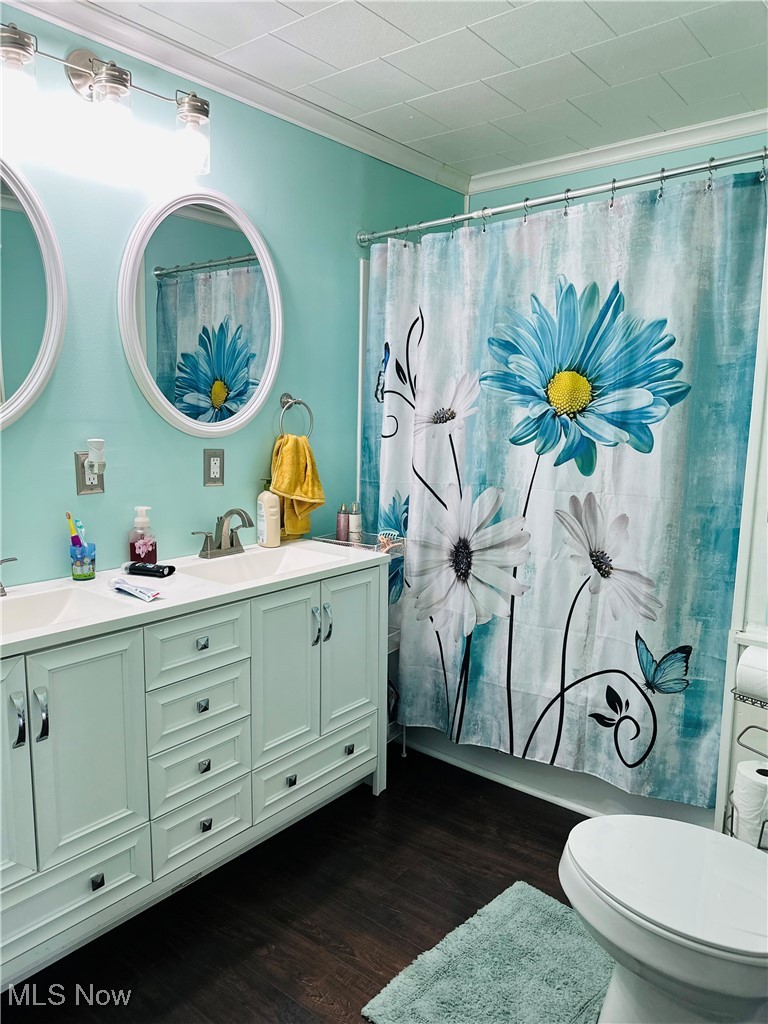 418 Main Street Philo, OH 43771 - Photo 20 of 37 Full bathroom with double vanity, wood finished floors, toilet, and a shower with curtain