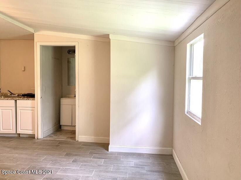 2806 Tropic Road Melbourne, FL 32935 - Photo 4 of 17 an empty room with windows and closet