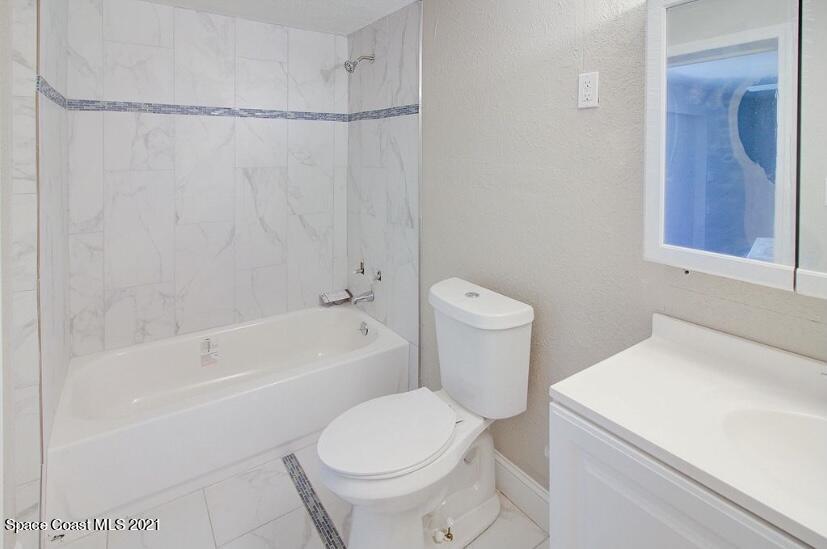 2806 Tropic Road Melbourne, FL 32935 - Photo 6 of 17 a white toilet sitting next to a bath tub