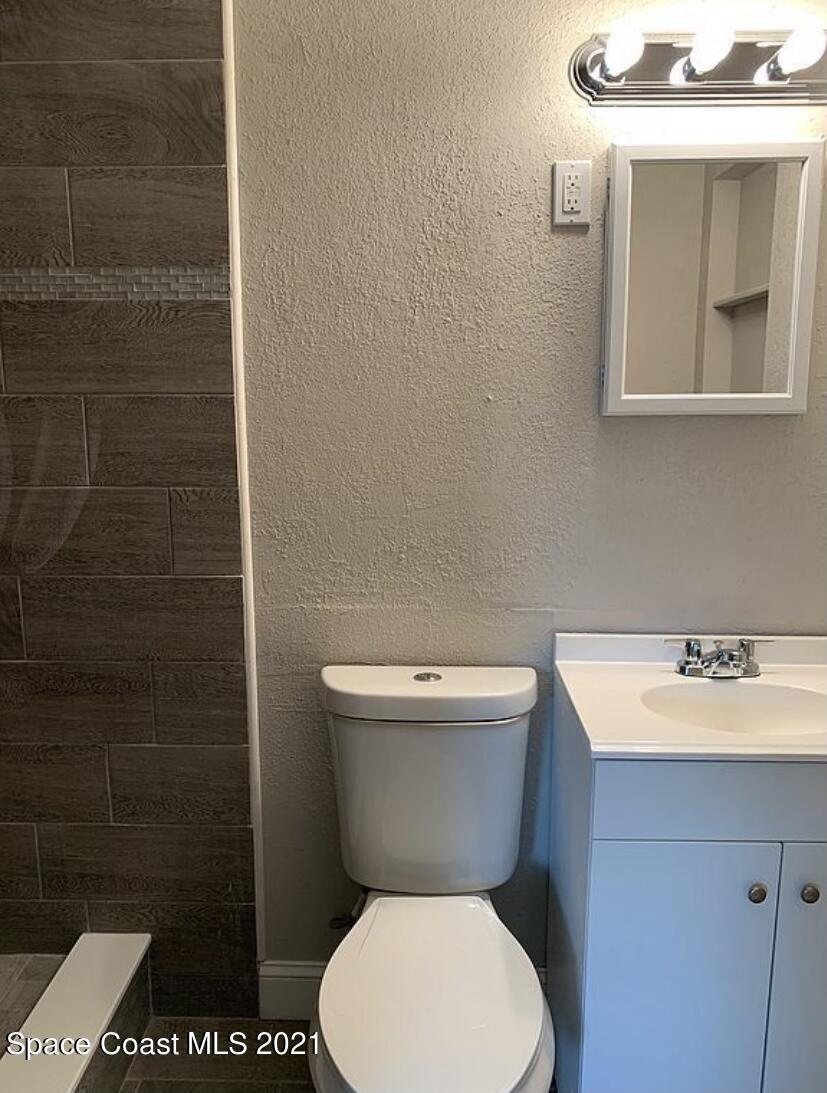 2806 Tropic Road Melbourne, FL 32935 - Photo 9 of 17 a white toilet sitting next to a bathroom sink