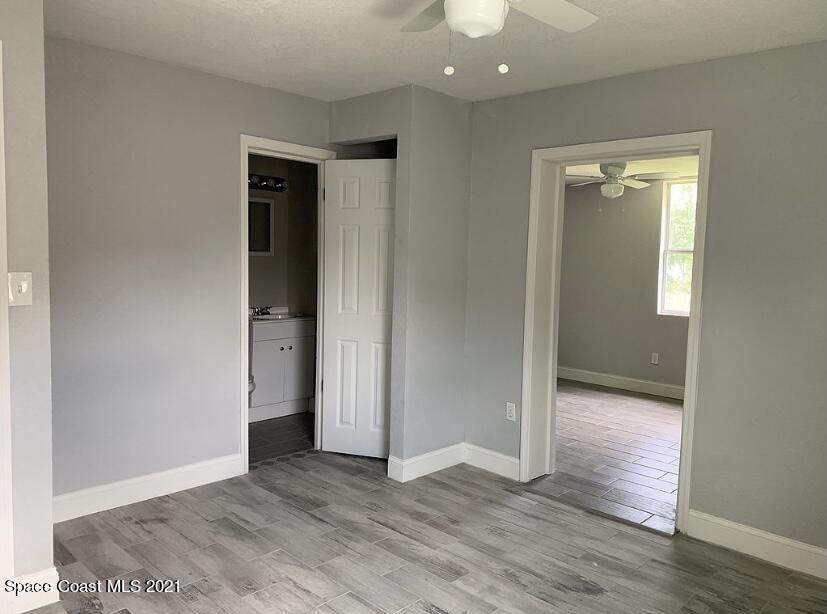 2806 Tropic Road Melbourne, FL 32935 - Photo 10 of 17 an empty room with wooden floor and windows