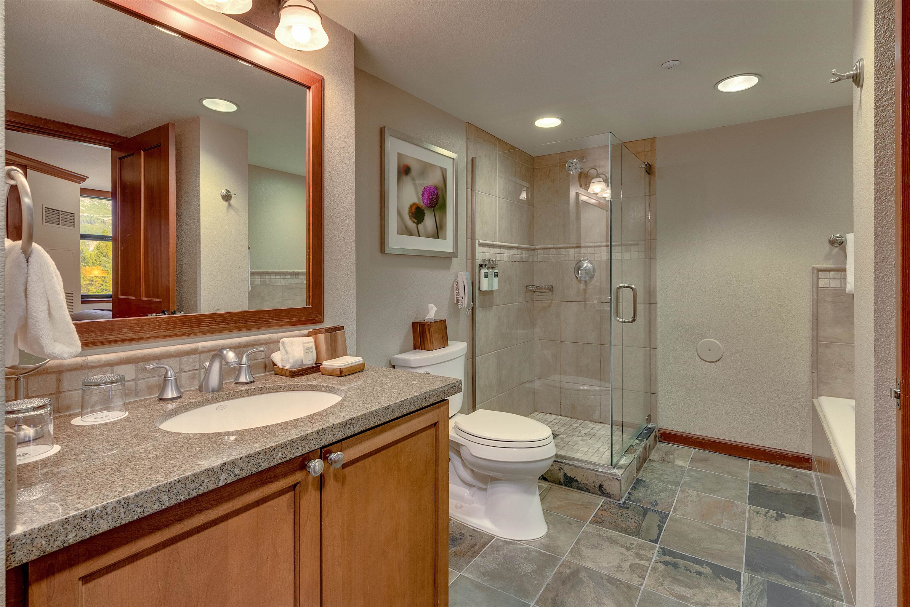 400 Resort Road, Unit 310 312 Olympic Valley, CA 96146 - Photo 6 of 21 a bathroom with a granite countertop sink a toilet a mirror and shower