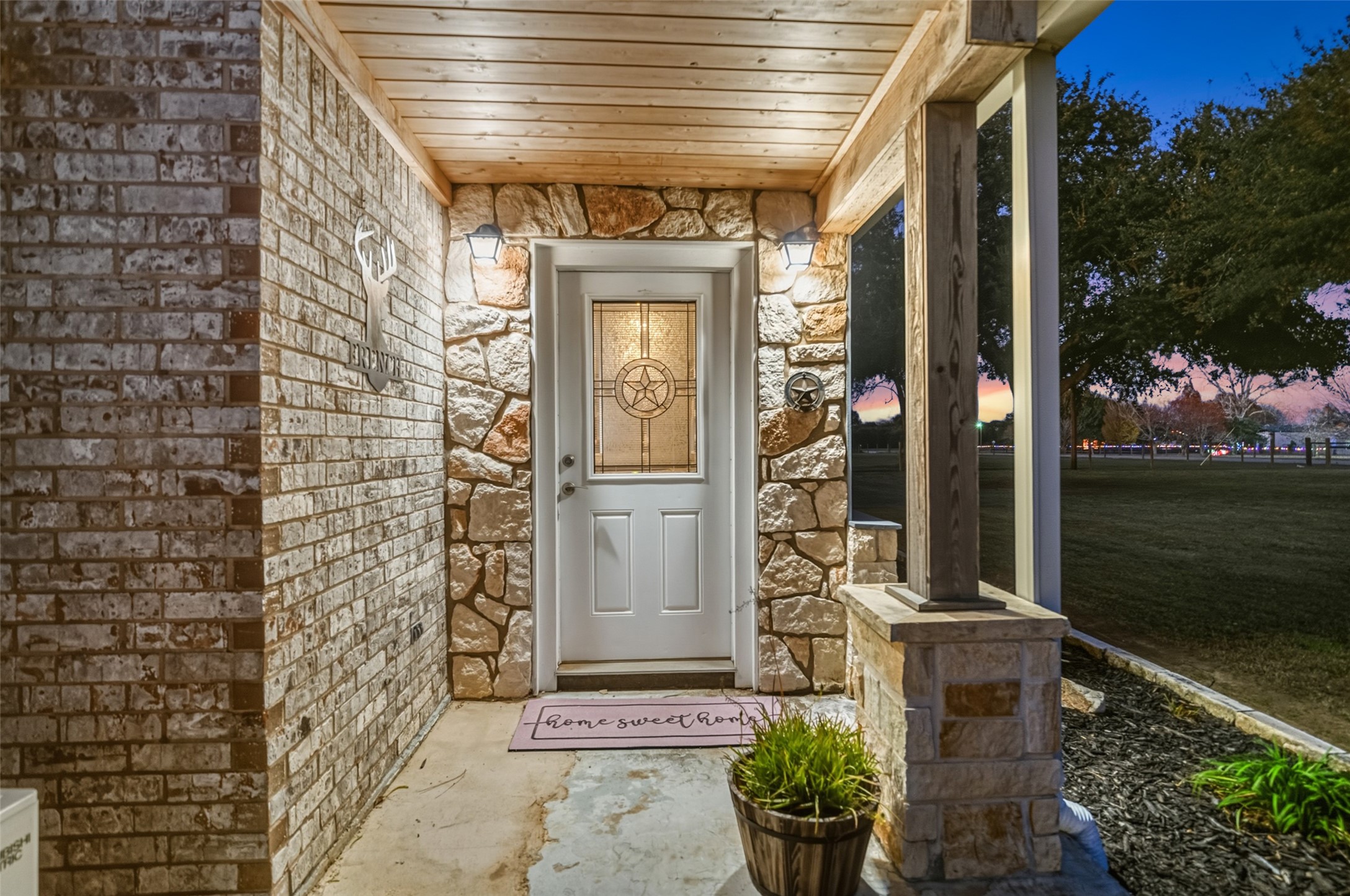 19989 Meadow Bend Road Hempstead, TX 77445 - Photo 11 of 35 Enclosed front porch features stone accents, covered entry, and welcoming lighting for everyday use and guest arrival.