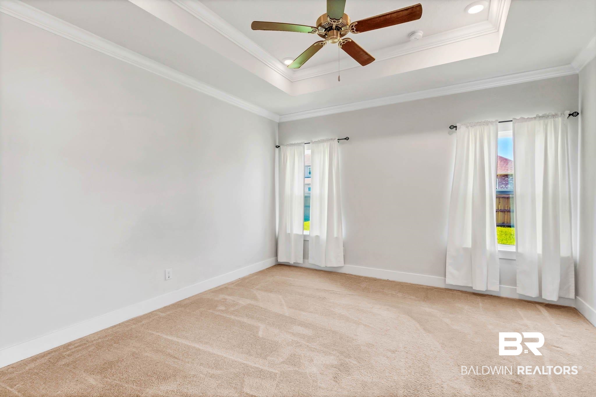 16461 Prado Loop Loxley, AL 36551 - Photo 41 of 78 Spare room with a raised ceiling, ornamental molding, light carpet, and ceiling fan