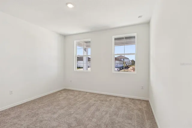 a view of an empty room and closet area