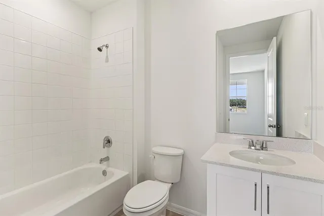 an empty room with wooden floor chandelier and windows