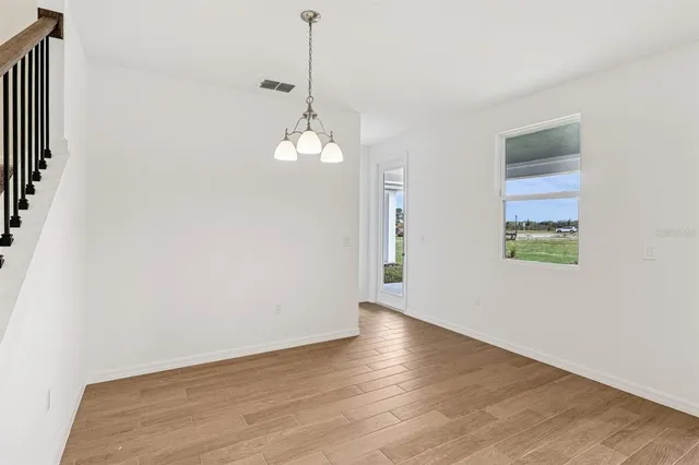 a view of a kitchen with wooden floor and staircase