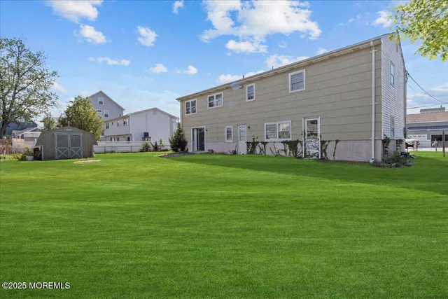 a backyard of a house with potted plants and large tree