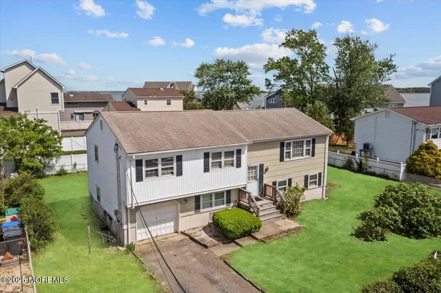 a aerial view of a house next to a yard