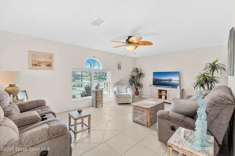 a living room with furniture a couch and a chandelier