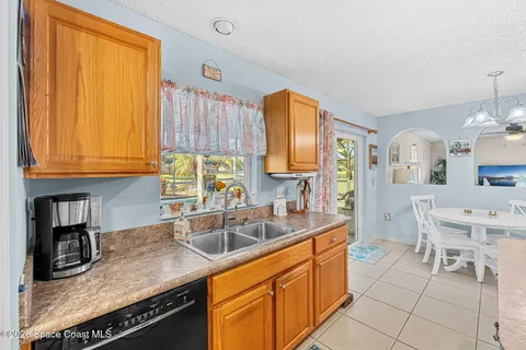 a large kitchen with granite countertop a large counter top and stainless steel appliances