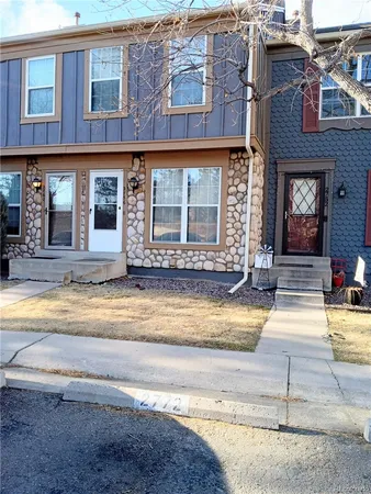 a front view of a brick house with a garage