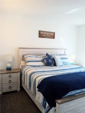 a bedroom with a bed and a lamp