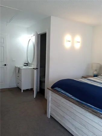a room with a bed and a mirror