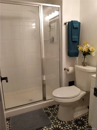 a bathroom with a toilet and a shower