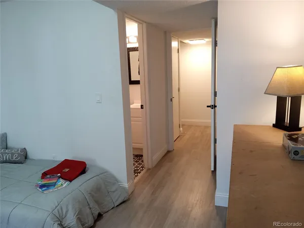 a bedroom with a bed and a lamp