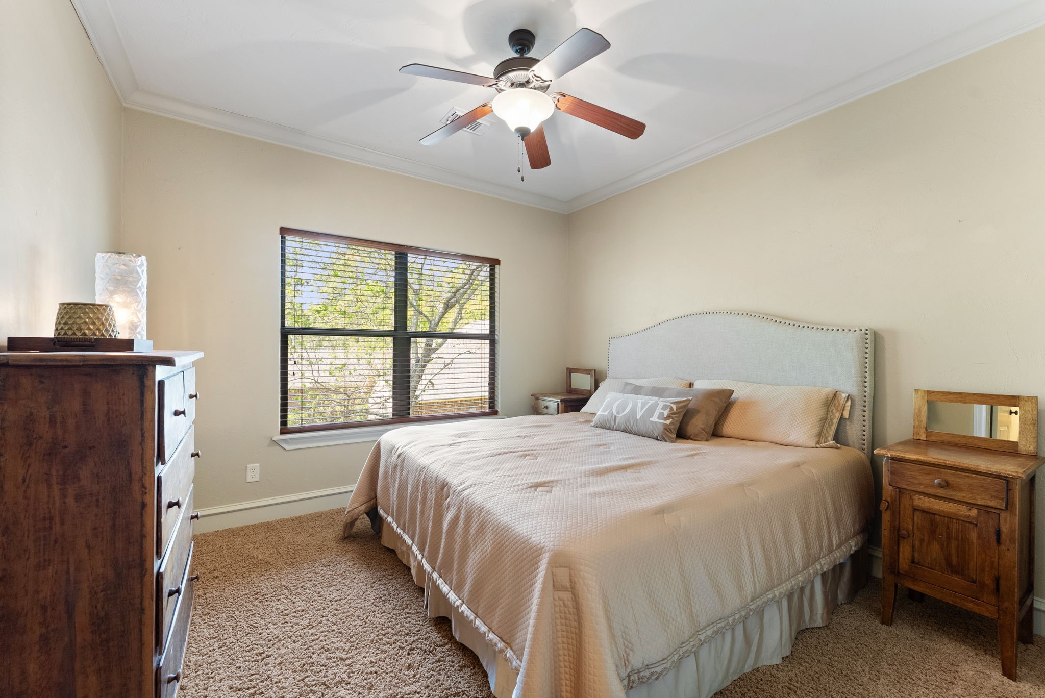 3907 Rayford Road Spring, TX 77386 - Photo 26 of 38 The second upstairs bedroom features crown molding, a ceiling fan, a large window for natural light, and generous closet space.