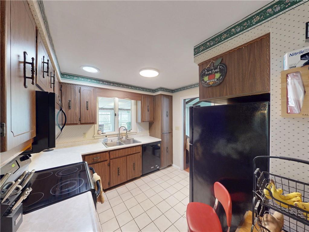 225 Fairway Lane Butler, PA 16002 - Photo 15 of 43 a kitchen with stainless steel appliances kitchen island granite countertop a refrigerator and a stove top oven