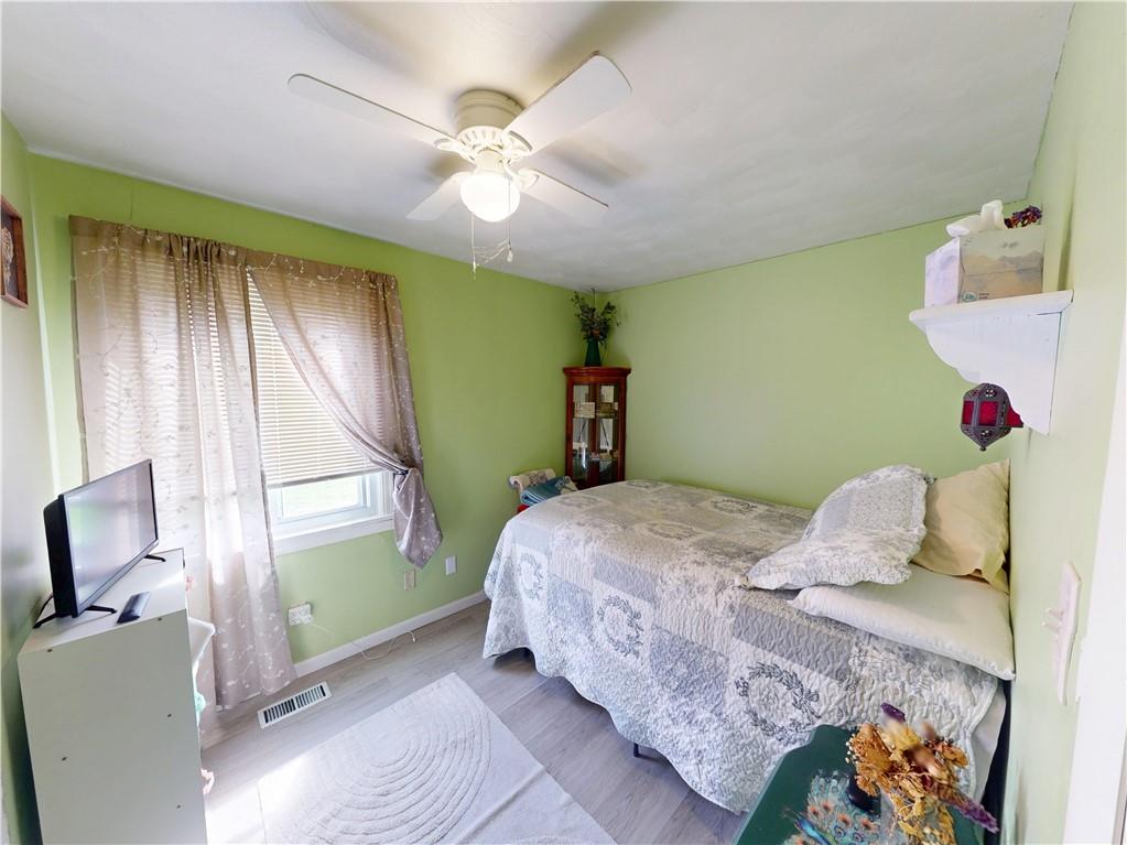 225 Fairway Lane Butler, PA 16002 - Photo 21 of 43 a bedroom with a bed and a chandelier