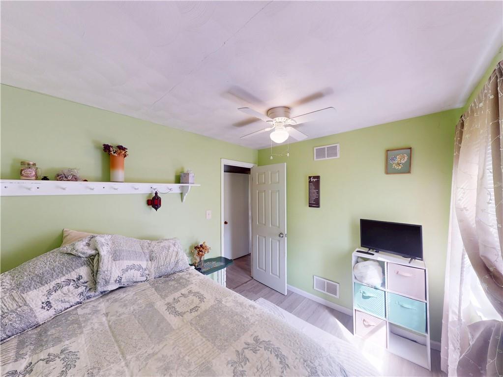 225 Fairway Lane Butler, PA 16002 - Photo 22 of 43 a bedroom with a bed and a flat tv screen on dresser