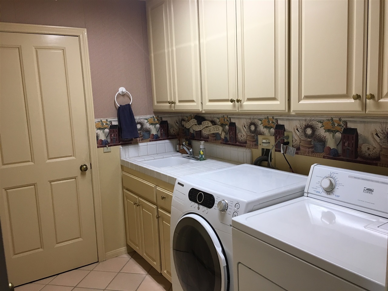935 Crescent Bend Fallbrook, CA 92028 - Photo 14 of 25 Check out this great Laundry Room with plenty of upper & lower cabinets. Plus stairs to attic storage.
