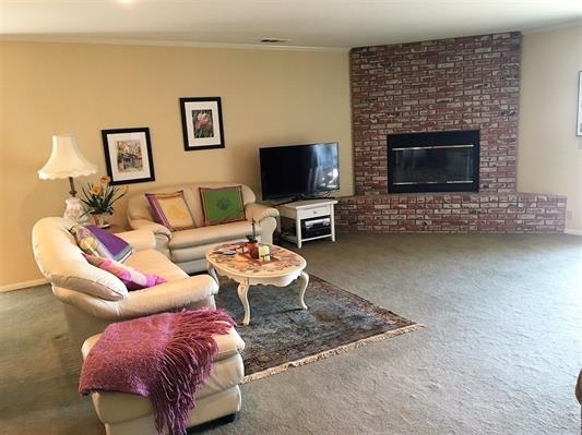 935 Crescent Bend Fallbrook, CA 92028 - Photo 3 of 25 Just imagine cozy evenings in front of this beautiful fireplace. This room is Very large with access to the rear patio, VIEWS & also a side patio.