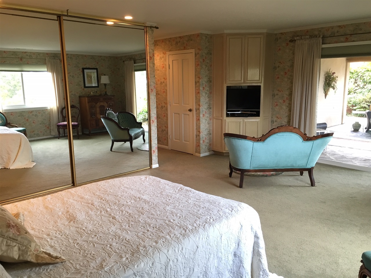 935 Crescent Bend Fallbrook, CA 92028 - Photo 6 of 25 Spacious Master Bedroom offers a sitting area & direct access to the rear patio. Extra closets include behind the floor-to-ceiling mirrored doors & a separate walk-in closet.