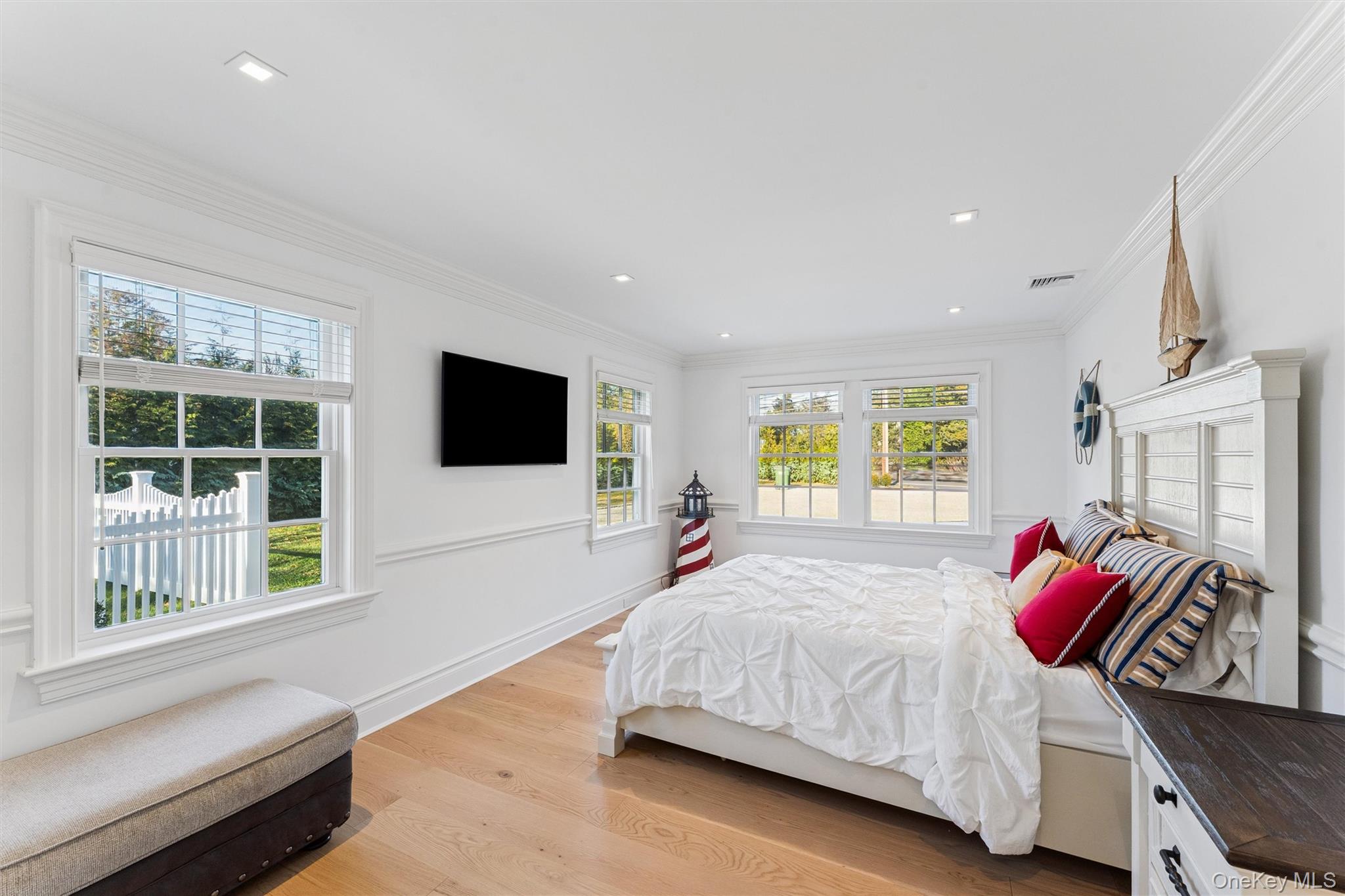 275 Mill Road Westhampton Beach, NY 11978 - Photo 10 of 23 Bedroom with light wood floors and wainscoted walls.
