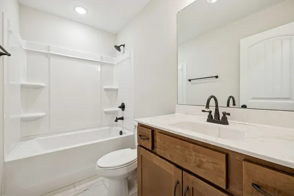 a bathroom with a sink a toilet and a bathtub