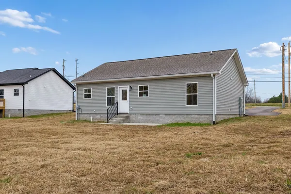 a view of a house with a backyard